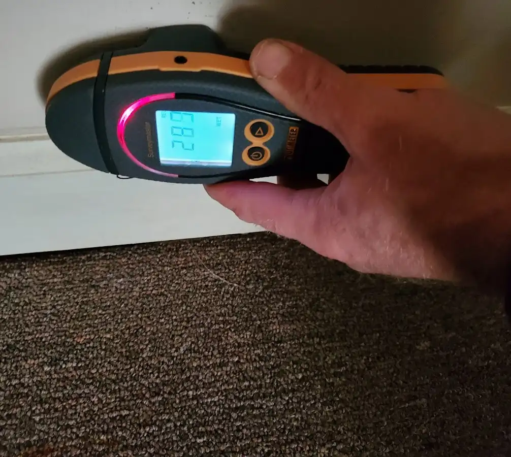 Moisture detection at baseboard during Storm Damage Restoration in Newington